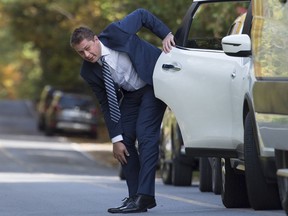 Conservative leader Andrew Scheer stops to fix his pant leg as he gets out of his car prior to making a morning announcement during a campaign stop in Lacolle, Que., Oct. 9, 2019. Outgoing Conservative Leader Scheer's past became a problem during the 2019 federal election, and those vying to replace him will be grilled about theirs.