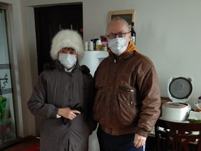 Wayne Duplessis, right, and his wife Emily Tjandra pose for a photo in their home in Wuhan, China in this handout photo. (THE CANADIAN PRESS/HO, Wayne Duplessis)