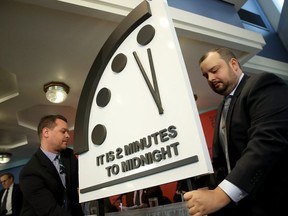 The Bulletin of the Atomic Scientists unveil the 2018 "Doomsday Clock" on Jan. 25, 2018 in Washington, DC. Citing growing nuclear risks and unchecked climate dangers, the group moved the clock to two minutes before midnight, 30 seconds closer and the closest it has been since the height of the Cold War in 1953. (Photo by Win McNamee/Getty Images)