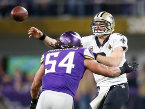 Saints QB Drew Brees throws a pass under pressure from Vikings' Eric Kendricks during the 2018 NFC Divisional Playoff game at U.S. Bank Stadium in Minneapolis, Jan. 14, 2018.