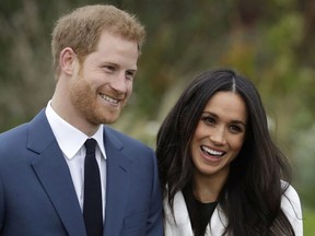 In this Monday Nov. 27, 2017 file photo, Britain's Prince Harry and his fiancee Meghan Markle pose for photographers during a photocall in the grounds of Kensington Palace in London.