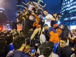 In this June 14, 2019, file photo, fans fill the streets of downtown Toronto, celebrating the Raptors victory over the Golden State Warriors in the NBA Finals.