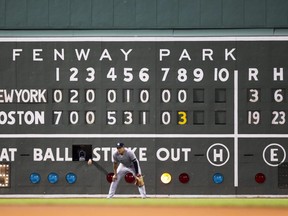 The scoreboard on the Green Monster shows the 19-3 score in the 8th inning of a game between the Red Sox and Yankees at Fenway Park in Boston on July 25, 2019.