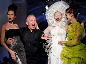 In this July 6, 2016, file photo, French designer Jean Paul Gaultier appears with models at the end of his Haute Couture Fall/Winter 2016/2017 collection in Paris, France.