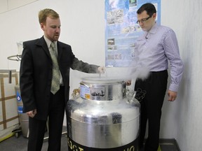 Head of Russian cryonics firm KrioRus Danila Medvedev (L) and KrioRus customer Innokenty Osadchy (R) looks inside a low-temperature human brain storage unit just outside Moscow on June 17, 2010.