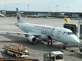 An Air Canada express jet Embraer sits at gate at MontréalPierre Elliott Trudeau International Airport (YUL) on July 16, 2019 (Daniel SLIM / AFP)