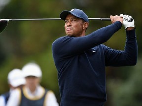 Tiger Woods plays a tee shot on the 11th hole during The Challenge: Japan Skins golf competition at Accordia Golf Narashino Country Club.