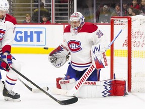 Canadiens goaltender Charlie Lindgren watches a second-period shot by the Carolina Hurricanes at PNC Arena in Raleigh, N.C.