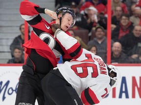 Senators winger Brady Tkachuk, left, fights with Devils defenceman P.K. Subban in the second period of Monday's game at Canadian Tire Centre.