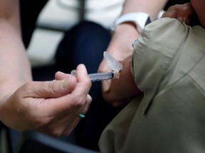 A registered nurse administers a vaccination to a young boy in Mount Vernon, Ohio, on May 17, 2019.