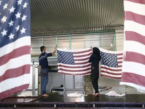 Iranian workers collect U.S. flags after making them at a large flag factory which creates U.S. and Israeli flags for Iranian protesters to burn in Khomein City, Iran January 28, 2020. Picture taken January 28, 2020.