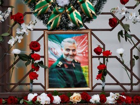 Flowers lie around a portrait of Iranian Major-General Qassem Soleimani, who was killed in an airstrike near Baghdad, at the Iranian embassy's fence in Minsk, Belarus January 10, 2020. (REUTERS/Vasily Fedosenko)