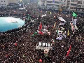 Iranian mourners take part in a funeral procession in Enghelab square in the capital Tehran on Monday, Jan. 6, 2020, for slain military commander Qaseem Soleimani, Iraqi paramilitary chief Abu Mahdi al-Muhandis, and other victims of a US attack last week.