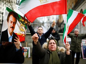 People hold a demonstration, in support of the ongoing anti-regime protests happening in Iran, outside Downing Street in London, January 13, 2020. (REUTERS/Henry Nicholls)