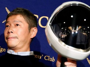 Japanese billionaire Yusaku Maezawa, founder and chief executive of online fashion retailer Zozo, who has been chosen as the first private passenger by SpaceX, poses for photos as he attends a news conference at the Foreign Correspondents' Club of Japan in Tokyo, Japan, October 9, 2018.