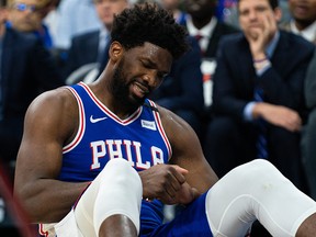 Philadelphia 76ers centre Joel Embiid (21) reacts after falling on his injured hand against the Oklahoma City Thunder at Wells Fargo Center. (Bill Streicher-USA TODAY Sports)