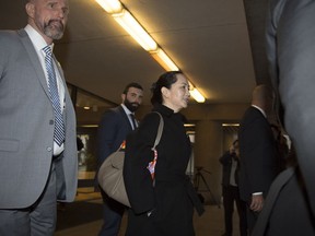 Meng Wanzhou chief financial officer of Huawei is surrounded by security as she leaves B.C. Supreme Court in Vancouver, Wednesday, Jan. 22, 2020.