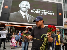 A fans mourns the death of retired NBA star Kobe Bryant outside the Staples Center prior to the 62nd Annual Grammy Awards on Jan. 26, 2020 in Los Angeles.