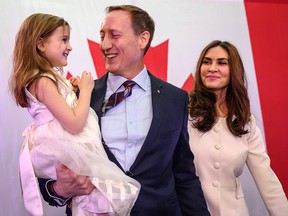 Peter MacKay, centre, holds his daughter Valentia MacKay as his wife Nazanin Afshin-Jam, looks on following MacKay's official campaign launch for leader of the Conservative Party of Canada in Stellarton, N.S. on Saturday, Jan. 25, 2020.