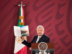 Mexico's President Andres Manuel Lopez Obrador shows a brochure of the 787 Dreamliner belonging to the Mexican Presidency, during a news conference at the National Palace in Mexico City, Mexico January 14, 2020.