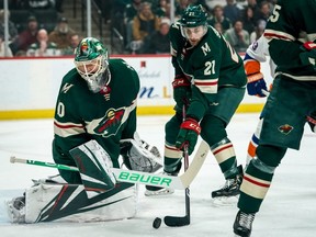 Wild defenceman Carson Soucy (21) clears the puck after a save from goalie Devan Dubnyk (40) during first period NHL action against the Islanders at Xcel Energy Center in St. Paul, Minn., Dec. 29, 2019.