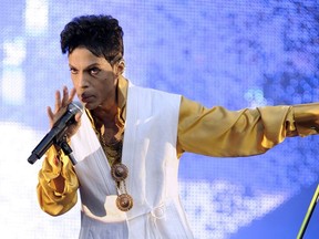US singer and musician Prince (born Prince Rogers Nelson) performs on stage at the Stade de France in Saint-Denis, outside Paris, on June 30, 2011.