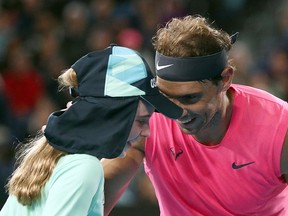 Rafael Nadal speaks with a ball girl after she is struck with a ball during his Aussie Open  match against Federico Delbonis in Melbourne. (REUTERS/Hannah McKay)