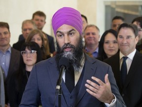 Surrounded by caucus members, NDP Leader Jagmeet Singh speaks with the media following the second day of caucus meetings in Ottawa, Thursday, Jan. 23, 2020.