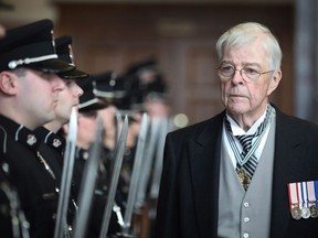 Newfoundland and Labrador Lieutenant Governor John Crosbie inspects the Royal Newfoundland Constabulary as he enters the House of Assembly to deliver the throne speech in St.John's, Monday, March 21, 2011.