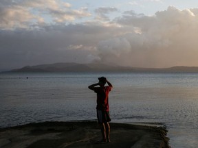 A looks at the Taal Volcano as continues to erupt in Talisay, Batangas, Philippines, January 14, 2020.