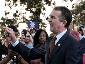 Virginia Governor Ralph Northam speaks to gun control activists at a rally by Moms Demand Action and other family members of shooting victims outside of the Virginia State Capitol Building in Richmond, Virginia, U.S. July 9, 2019. (REUTERS/Michael A. McCoy/File Photo)