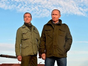Russian President Vladimir Putin (R) and Prime Minister Dmitry Medvedev are seen during their tour on Lake Ilmen in Novgorod region, Russia, September 10, 2016.