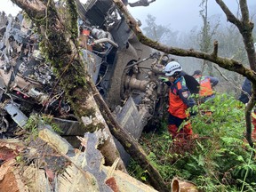 A rescue team searches for missing military officers after a Black Hawk helicopter made a forced landing at a mountainous area near Taipei, Taiwan January 2, 2020. (Yilan County Fire Bureau/Handout via REUTERS)
