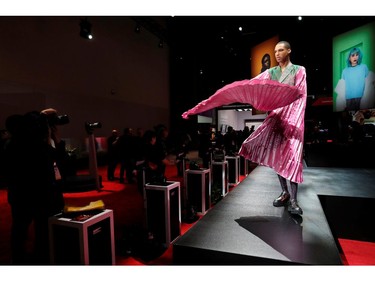 A model poses for photographers at the Canon booth during the 2020 CES in Las Vegas on Jan. 8, 2020.