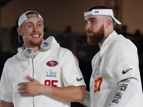 San Francisco 49ers tight end George Kittle (left) greets Kansas City Chiefs tight end Travis Kelce during Super Bowl LIV Opening Night at Marlins Park on Monday. USA TIDAY