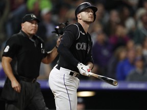 Colorado Rockies shortstop Trevor Story, right, watches his solo home run against the Milwaukee Brewers Saturday, Sept. 28, 2019, in Denver. (AP Photo/David Zalubowski)