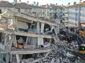 Rescue workers work at the scene of a collapsed building  on Jan. 26, 2020, in Elazig, Turkey.