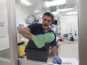 Rick Mazda, environmental attendant scrubs down negative pressure clean room at Humber River Hospital, where they are ready if the Coronavirus spreads, on Thursday, Jan. 7, 2021.