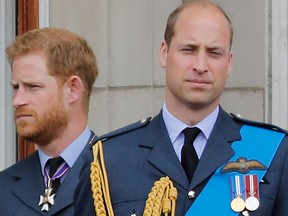 In this file photo taken on July 10, 2018 Britain's Prince Harry and Prince William stand on the balcony of Buckingham Palace on July 10, 2018 to watch a military fly-past to mark the centenary of the Royal Air Force (RAF). (TOLGA AKMEN/AFP via Getty Images)