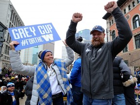 Winnipeg Blue Bombers head coach Mike O'Shea (right) celebrates during the Grey Cup parade on Tues., Nov. 26, 2019.