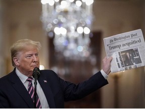 U.S. President Donald Trump holds a copy of The Washington Post as he speaks in the East Room of the White House one day after the U.S. Senate acquitted on two articles of impeachment, ion Feb. 6, 2020 in Washington, D.C.