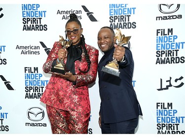Fredrica Bailey and Stefan Bristol pose in the press room with the Best First Screenplay award for the film "See You Yesterday" during the Independent Spirit Awards.