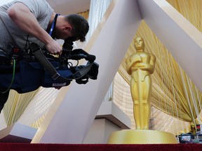 A cameraman films an Oscar statue on the red carpet as Oscars preparations continue for the 92nd Academy Awards in Hollywood, Los Angeles, Calif., Feb. 7, 2020. (REUTERS/Eric Gaillard)