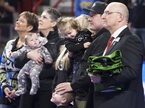 Scott Jenkins, husband of the late Saskatchewan player Aly Jenkins is seen with family, including his three children Brady, Avery and Sydney during a tribute to his wife prior to the 4th draw at the Scotties Tournament of Hearts in Moose Jaw, Sask., Sunday, Feb. 16, 2020. (THE CANADIAN PRESS/Jonathan Hayward)