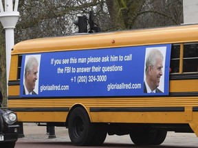 A yellow school bus with a message for Prince Andrew, from U.S. lawyer Gloria Allred, drives along The Mall towards Buckingham Palace in London Friday Feb. 21, 2020. (Stefan Rousseau/PA via AP)
