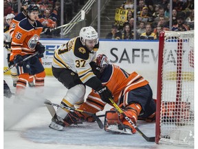 Goaltender Mike Smith (41) of the Edmonton Oilers, is beaten by Patrice Bergeron of the Boston Bruins at Rogers Place on Wednesday, Feb. 19, 2020.