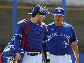 Toronto Blue Jays pitcher Shun Yamaguchi (1) talks with catcher Danny Jansen (9) as they walk to the dugout at Spring Training. Kim Klement-USA TODAY Sports