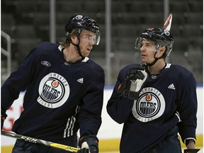 Edmonton Oilers captain Connor McDavid (left) skates with forward Tyler Ennis during team practice in Edmonton on Friday February 28, 2020.