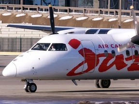 A Dash-8 Jazz airplane taxied out the runways for takeoff at the Calgary International Airport.