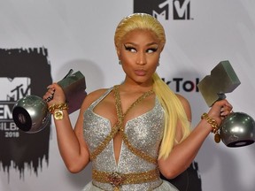 In this file photo taken on November 4, 2018 Trinidadian-US rapper Nicki Minaj poses backstage with her awards during the MTV Europe Music Awards at the Bizkaia Arena in the northern Spanish city of Bilbao.